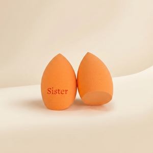 Oranžový beauty blender se zkosením dole s gravírovaným nápisem Sister